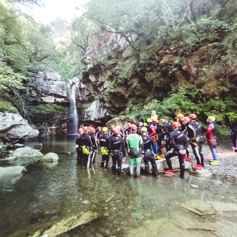 a group of people walking down a dirt road
